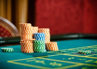 Mobile phone showing betting options and QRIS payment